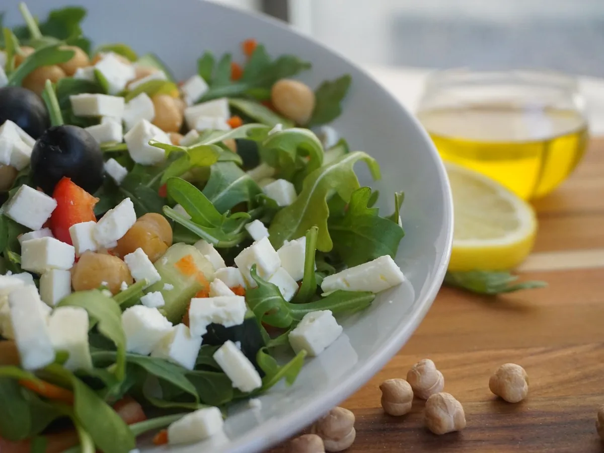 A colorful Mediterranean salad with feta, olives, chickpeas, and fresh greens.